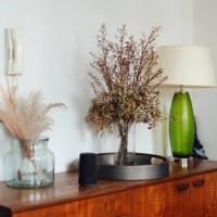 a corner of the living room - a retro style table lamp and some preserved flowers in vase on a wooden sideboard - home decoration stock pictures, royalty-free photos & images