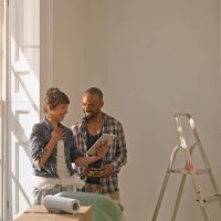 a couple discussing diy looking at an tablet computer - home decoration stock pictures, royalty-free photos & images