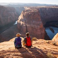 a couple hiking on the edge of a senic overlook. - travel stock pictures, royalty-free photos & images