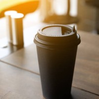 a cup of coffee on the wooden bar. coffee break. a disposable cup to go. tinted photo. - junk food stock pictures, royalty-free photos & images