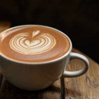 a cup of latte on wooden table - coffee stock pictures, royalty-free photos & images