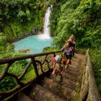 a family hiking at rio celeste waterfall in costa rica. - travel stock pictures, royalty-free photos & images