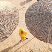 a fashionable woman walks along the beach - fashion stock-fotos und bilder