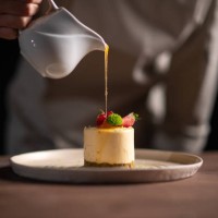 a female chef pouring sauce on a fruitcake - food stock pictures, royalty-free photos & images