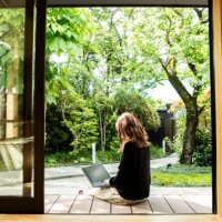 a female guest working on the porch of the guesthouse where she stayed during her trip to japan. - travel stock pictures, royalty-free photos & images