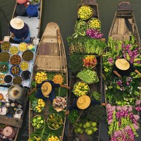 a floating market on a canal in thailand. boats laden with fresh produce, vegetables and fruit. market traders. - food stock pictures, royalty-free photos & images