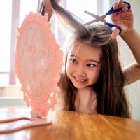 a girl about 6 years old cuts off her hair. - hairstyle stock pictures, royalty-free photos & images