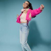 a girl in bright clothes with headphones and bright makeup jumps and smiles on a colored background in the studio - fashion stock pictures, royalty-free photos & images