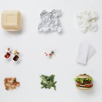 a hamburger aligned with all its associated waste - junk food stock pictures, royalty-free photos & images
