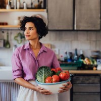 a happy beautiful woman holding a bowl of organic healthy vegeta - food stock pictures, royalty-free photos & images