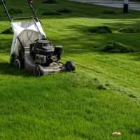 a lawn mower working in the grass - garden decoration stock pictures, royalty-free photos & images