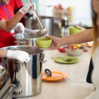 a line of hands serving food in a soup kitchen - food stock pictures, royalty-free photos & images