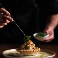 a male chef decorating a plate of tartare di pesce spada - food stock pictures, royalty-free photos & images