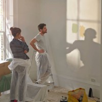 a man and woman doing diy in new home - home decoration stock pictures, royalty-free photos & images
