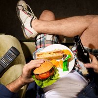 a man eats junk food - junk food stock pictures, royalty-free photos & images