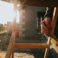a man sanding a wooden chair frame with a sanding block - home decoration stock pictures, royalty-free photos & images