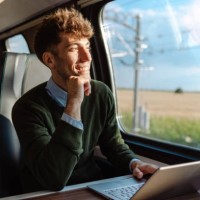 a man using a laptop during a train ride - travel stock pictures, royalty-free photos & images