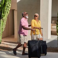 a mature couple arrive at a holiday villa - travel stock pictures, royalty-free photos & images