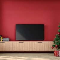 a nostalgic retro living room with with a tv on a cabinet in front of a red plaster wall and partly ruined brick wall and christmas decoration - home decoration stock pictures, royalty-free photos & images