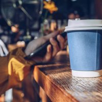 a paper cup of hot coffee in coffee shop. - junk food stock pictures, royalty-free photos & images