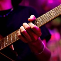 a professional male artist plays a rock guitar, the hand of a musician plays rock music. studio neon light. - concert stock pictures, royalty-free photos & images