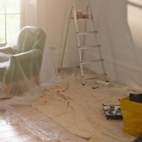 a room with dust sheets, a ladder and paint roller - home decoration stock pictures, royalty-free photos & images