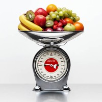 a selection of fruit on a weighing scale - food stockfoto's en -beelden