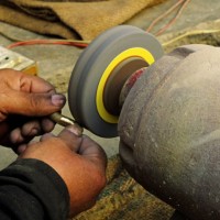 a senior worker is applying polish on a piece of handicraft - home decoration stock pictures, royalty-free photos & images