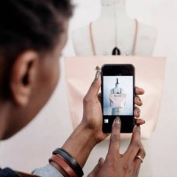 a small business owner takes a photo of her handmade leather bag, ready to upload to her website - fashion stock-fotos und bilder