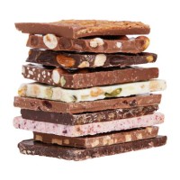 a stack of different chocolate isolated on white background - junk food stock pictures, royalty-free photos & images