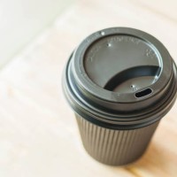 a still life of black disposable coffee cup - junk food stock pictures, royalty-free photos & images