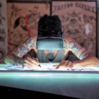 a tattoo artist in the studio design uses virtual reality glasses to draw a tattoo and see the colors how they will look - fashion stock pictures, royalty-free photos & images