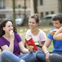 a teen group making a picnic in a park - junk food stock pictures, royalty-free photos & images