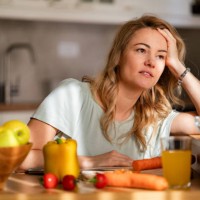 a tired woman is trying to prepare lunch while sitting in the kitchen - food stock pictures, royalty-free photos & images