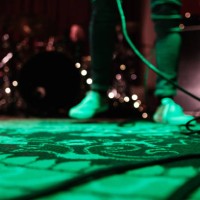 a unrecognizable musician standing on stage at a microphone during a show. blurred image. - concert stock pictures, royalty-free photos & images