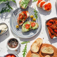 a variety of healthy toasts with vegetables, seeds and microgreens. colorful, plant-based vegan snacks. stylish table setting and food. catering. food delivery. festive table. - food stock pictures, royalty-free photos & imag