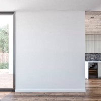 a white blank wall with a window door and garden and patio view in the foreground, a modern light grey kitchen with marble rectangular breakfast kitchen island in the background - garden decoration stock pictures, royalty-fre