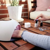 a woman applies a treatment to paint her fingernails - nails art stock pictures, royalty-free photos & images