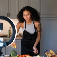 a woman cooking and live streaming a video - food stock pictures, royalty-free photos & images