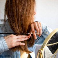 a woman cutting her own hair - hairstyle stock pictures, royalty-free photos & images