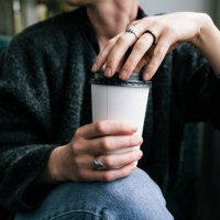 a woman holding a takeout coffee - junk food stock pictures, royalty-free photos & images