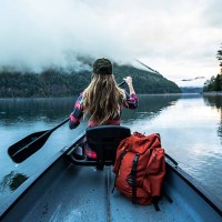 a woman in a canoe. - travel stock-fotos und bilder
