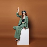 a woman in vertacular reality glasses sits and plays games on a colored background. concept technology and vertical reality. - fashion stock pictures, royalty-free photos & images
