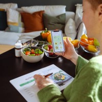 a woman is making a weekly nutrition plan and using mobile app - food stock pictures, royalty-free photos & images