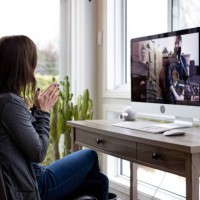 a woman is watching an online music concert from home for her birthday during covid-19 pandemic - concert stock pictures, royalty-free photos & images