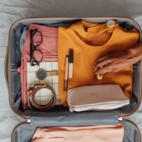 a woman packing her clothes in a suitcase - travel stock pictures, royalty-free photos & images