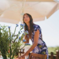 a woman sets the table for lunch - garden decoration stock pictures, royalty-free photos & images