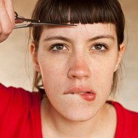 a woman trimming her own bangs - hairstyle stock pictures, royalty-free photos & images