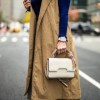 a woman with a smart watch holding a bag on the street of manhattan during busy working week - fashion stock pictures, royalty-free photos & images