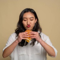 a young asian girl is eating - food stock pictures, royalty-free photos & images